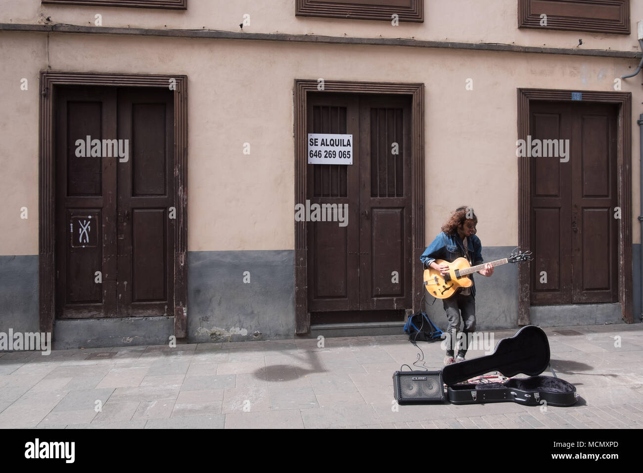 La Laguna,  Tenerife; a busker with his guitar on the streets of this university town popular with tourists. Stock Photo