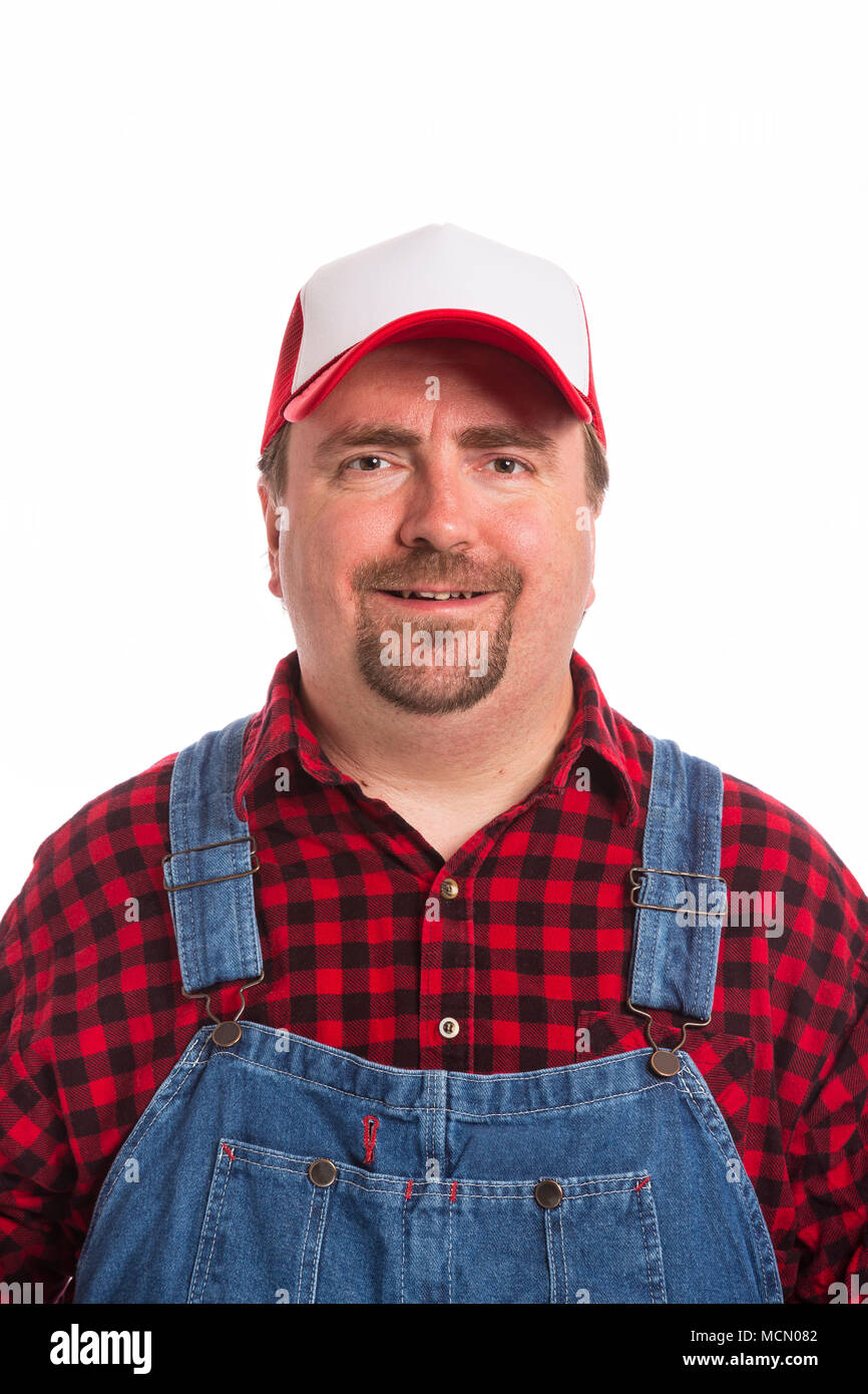 Male Workman in bib overalls, flannel shirt, and hat Stock Photo - Alamy