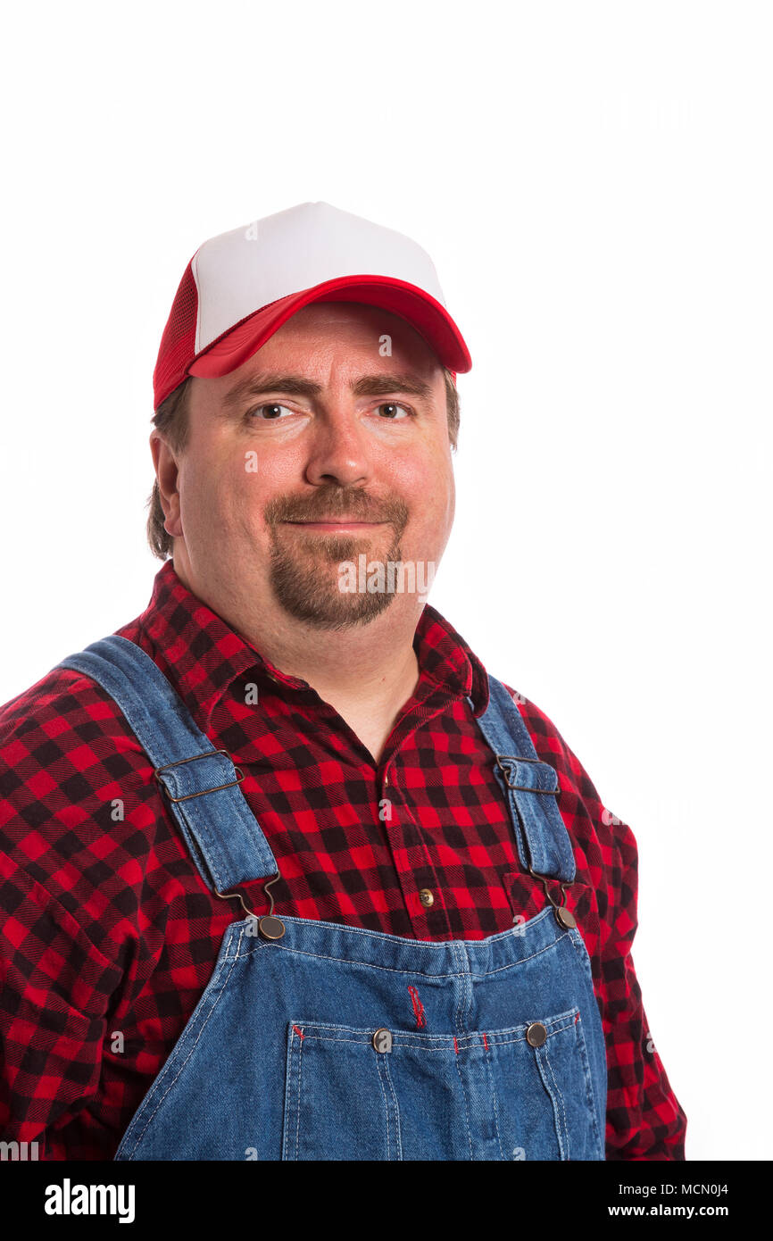 Male Workman in bib overalls, flannel shirt, and hat. Stock Photo