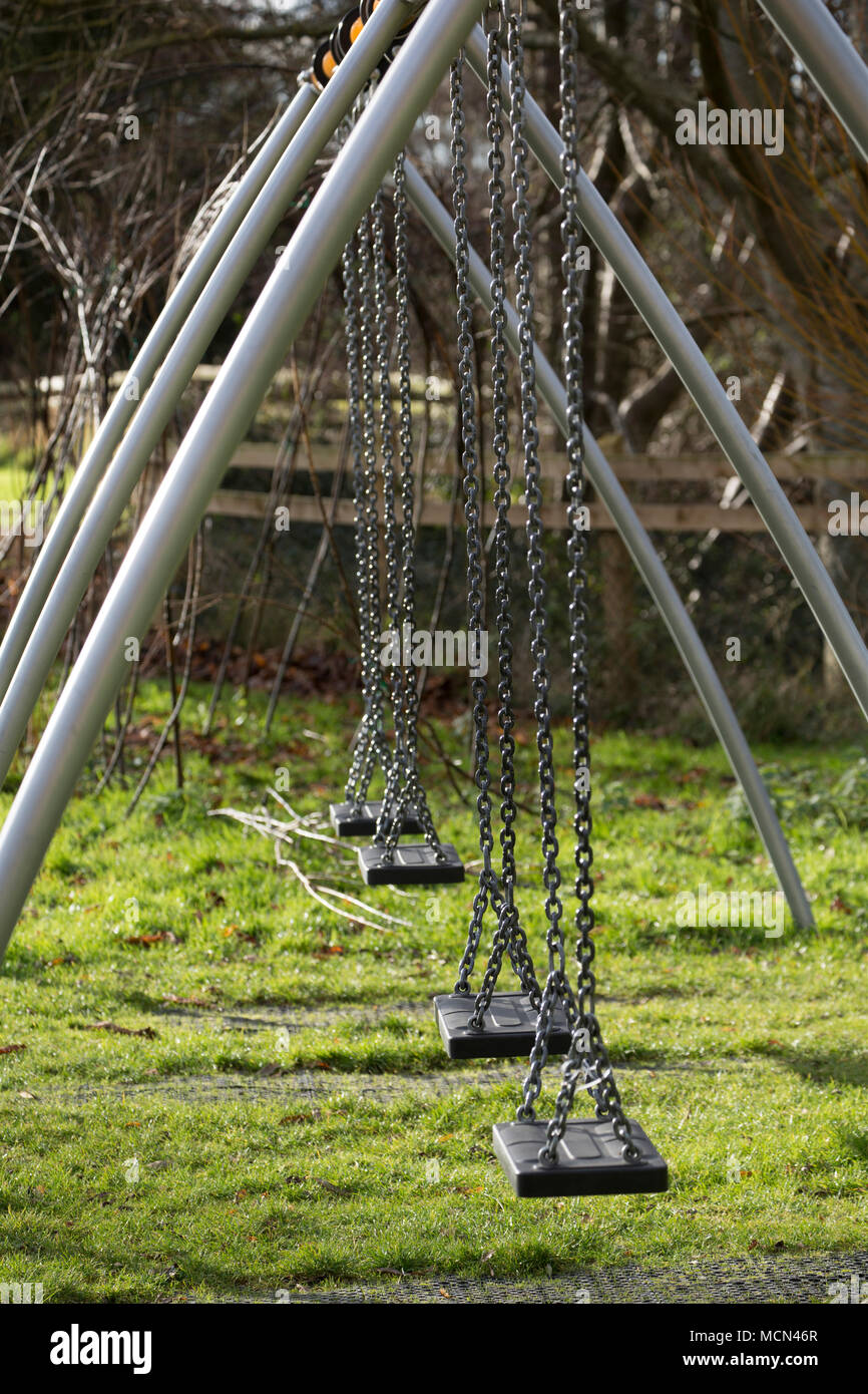 Childrens swings in a public park in Somerset UK Stock Photo