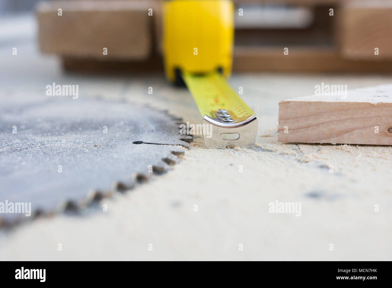 Shallow depth of field side view of shop tools; saw blade, tape measure