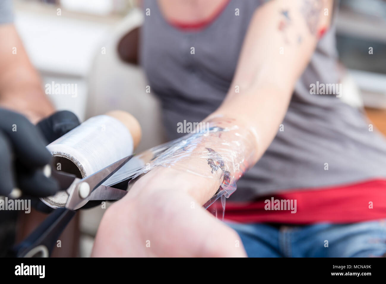 Close-up of the hands of a skilled tattoo artist Stock Photo