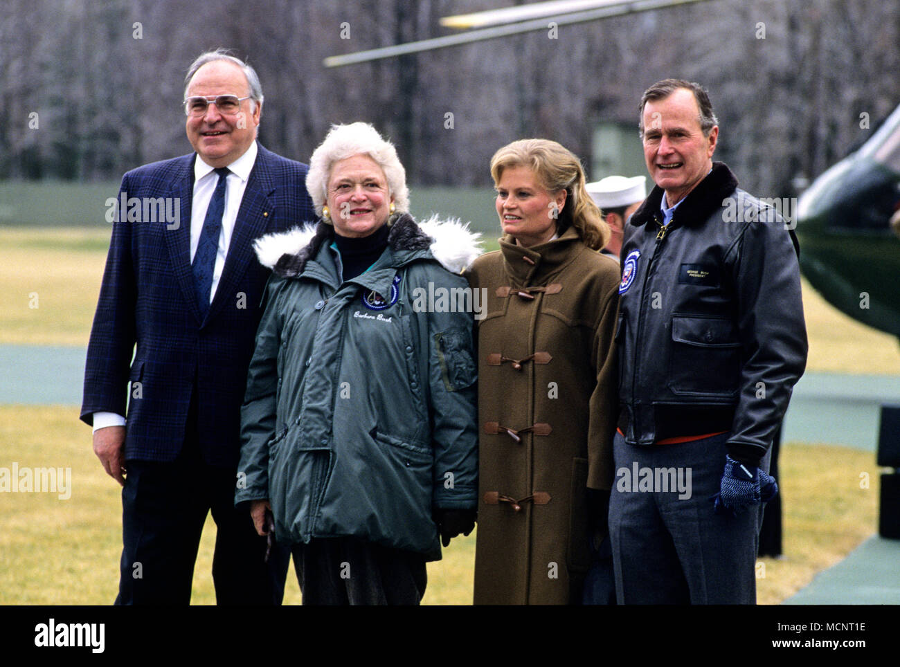 United States President George H.W. Bush, right, and first lady Barbara Bush, left center, welcome Chancellor Helmut Kohl of West Germany, left, and his wife, Hannelore, right center, to Camp David, the presidential retreat near Thurmont, Maryland on February 24, 1990. Credit: Ron Sachs/CNP Photo via Credit: Newscom/Alamy Live News Stock Photo