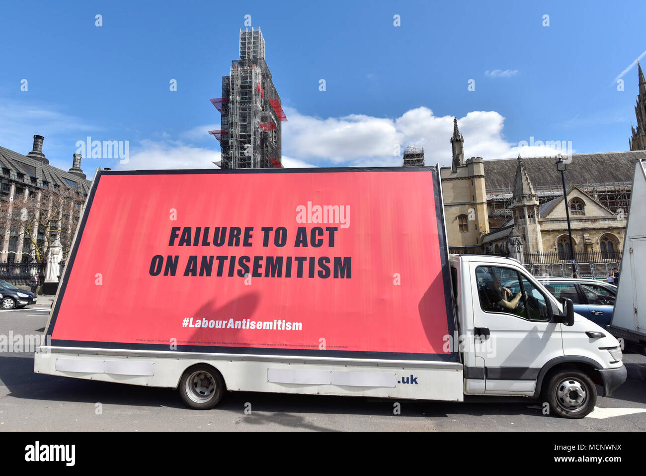 London, UK. 17 April 2018. Three vans, each carrying a mobile billboard  bearing a message protesting against anti-semitism within the Labour party,  drive around Parliament Square causing traffic disruption. Credit: Stephen  Chung /