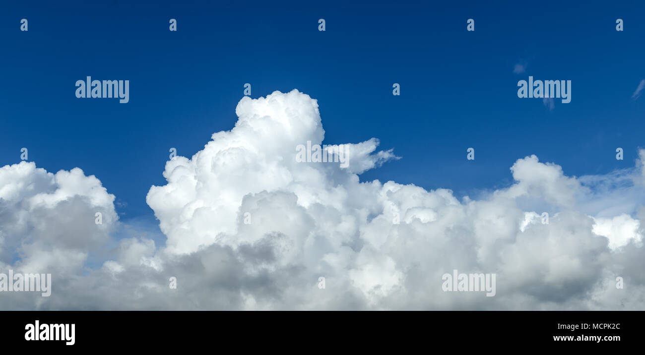 Blue sky and clouds above background Stock Photo