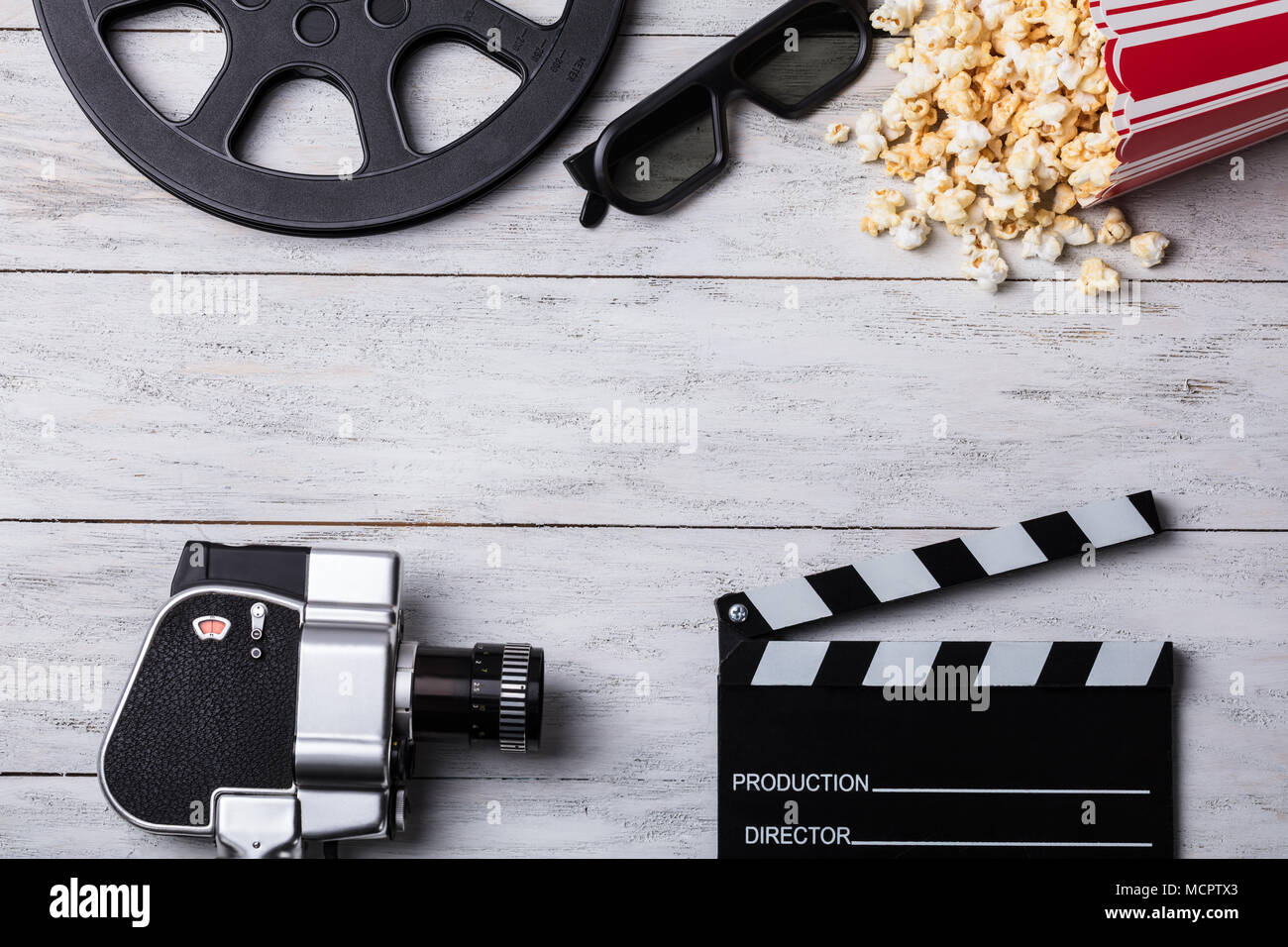 Elevated View Of Spilled Popcorn With Clapperboard 3d Glasses Film Reel And Movie Camera Stock Photo Alamy
