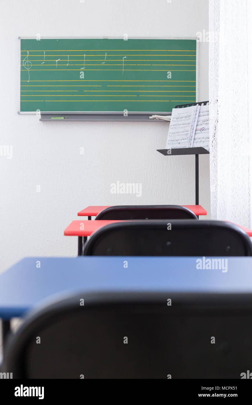 Greenboard and chairs in modern classroom for teaching music Stock Photo