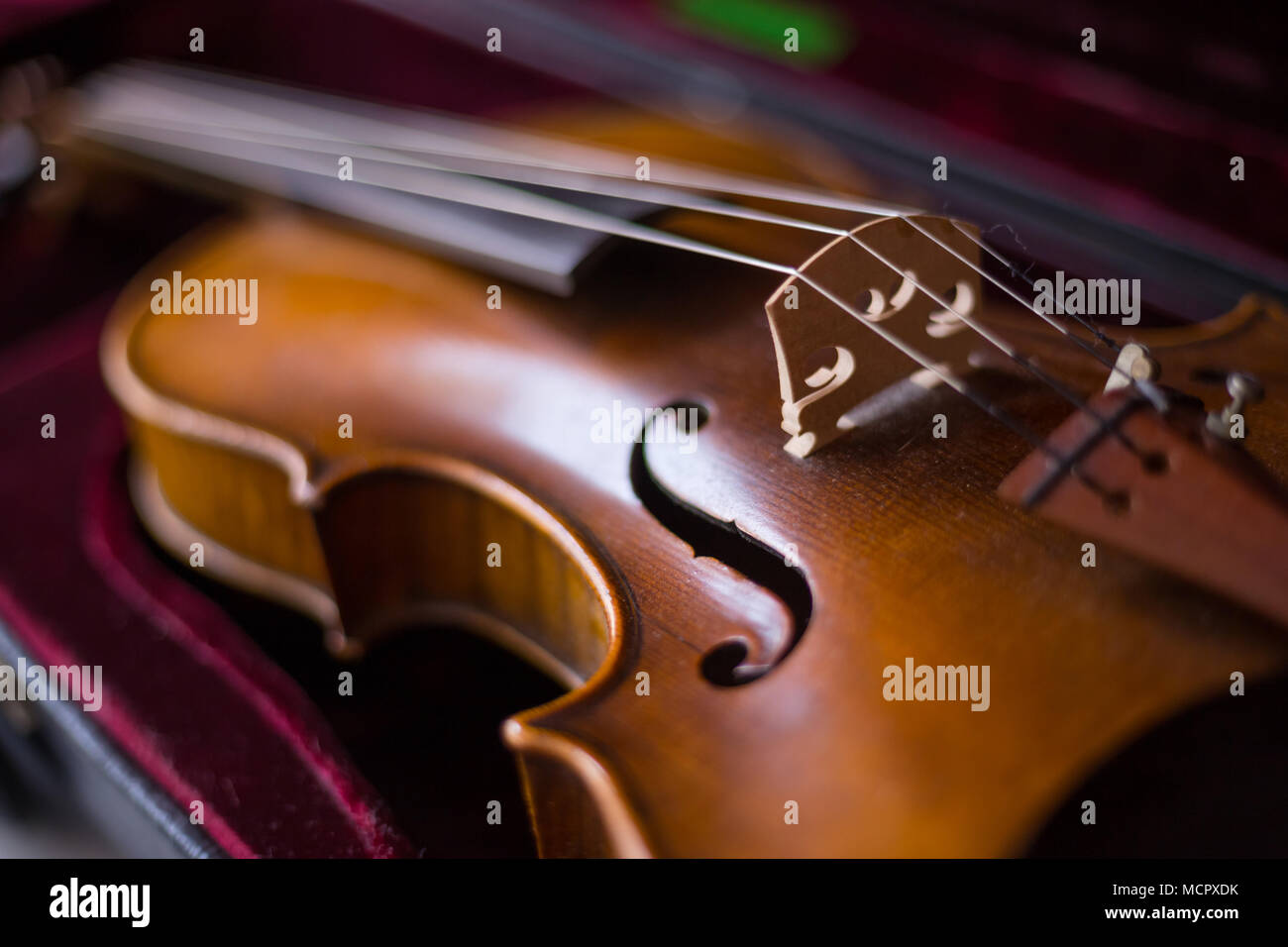 Violin and bow in dark red case. Close up Stock Photo