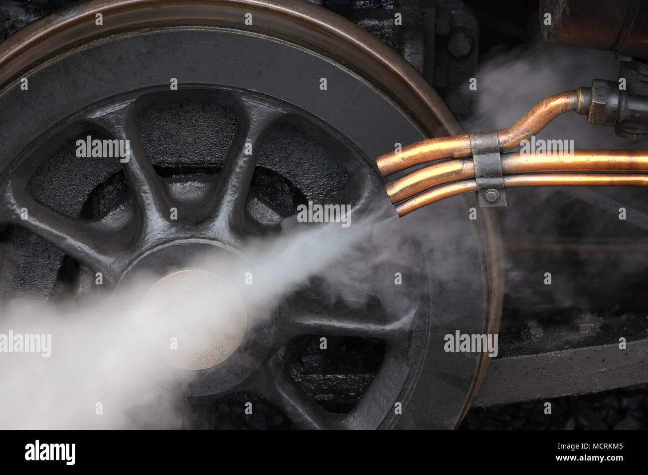 steam coming out of copper pipes on old locomotive engine Stock Photo