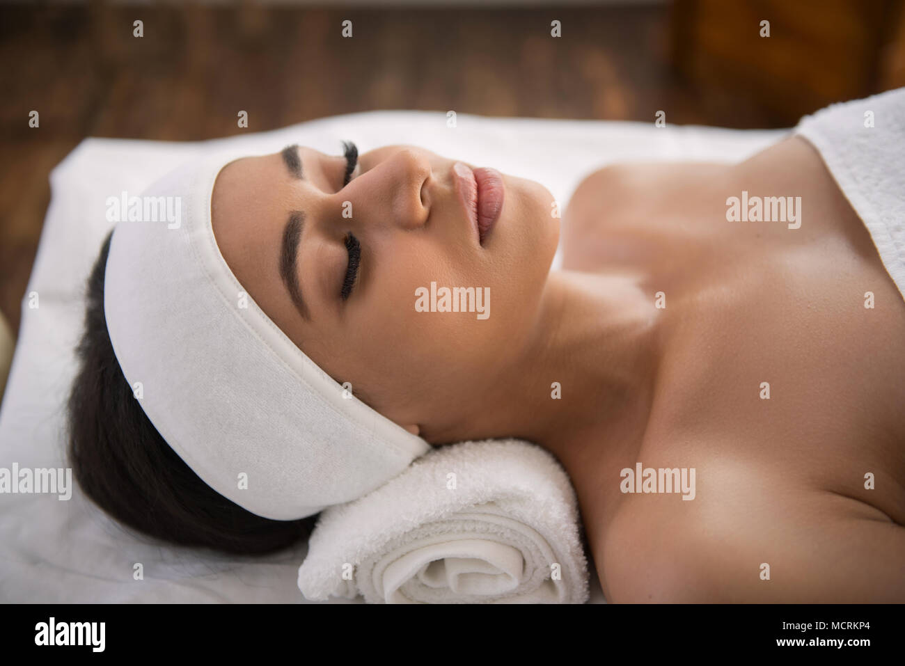 Nice delighted woman lying with her eyes closed Stock Photo - Alamy