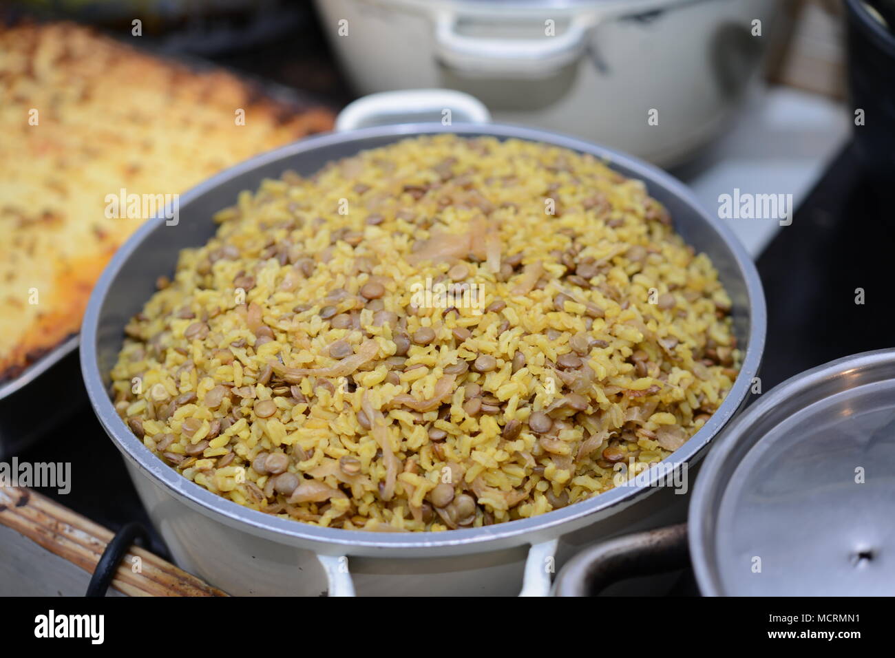 A pot of Majadara - rice with lentils and onions topped with parsley Stock Photo