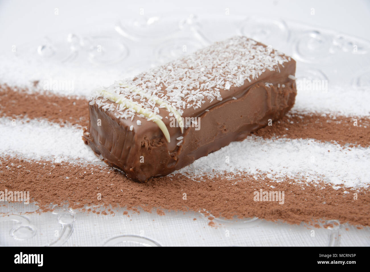 Chocolate cream cake garnished with coconut shavings Stock Photo