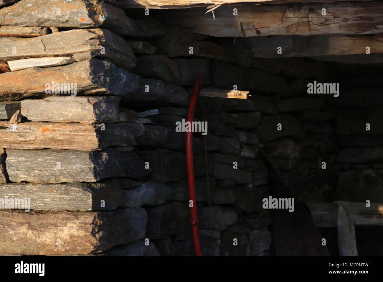 Saw Hanging On A Stone Wall Stock Photo