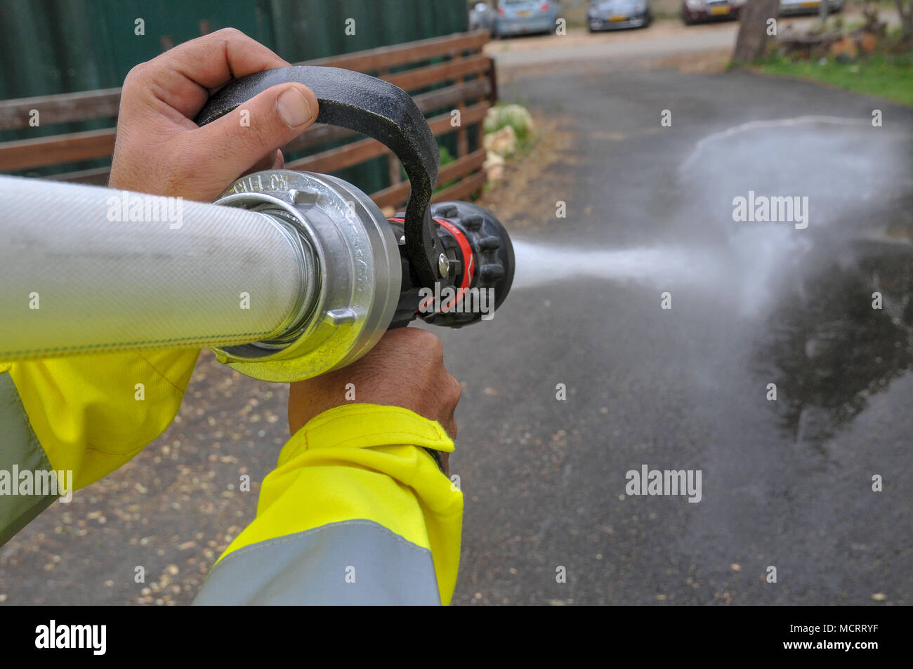 Fireman in protective clothing extinguishes a fire as part of a fire fighting drill Stock Photo