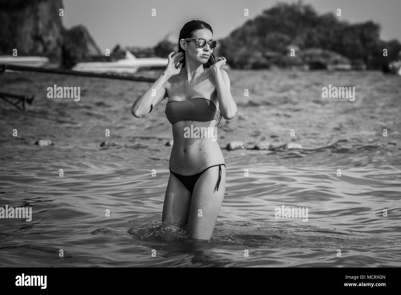 Young model, woman in bkini, bathing in Railay beach, popular travel destination near Krabi, Thailand. Stock Photo