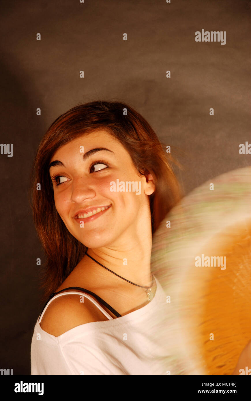 Young woman fanning herself. Stock Photo