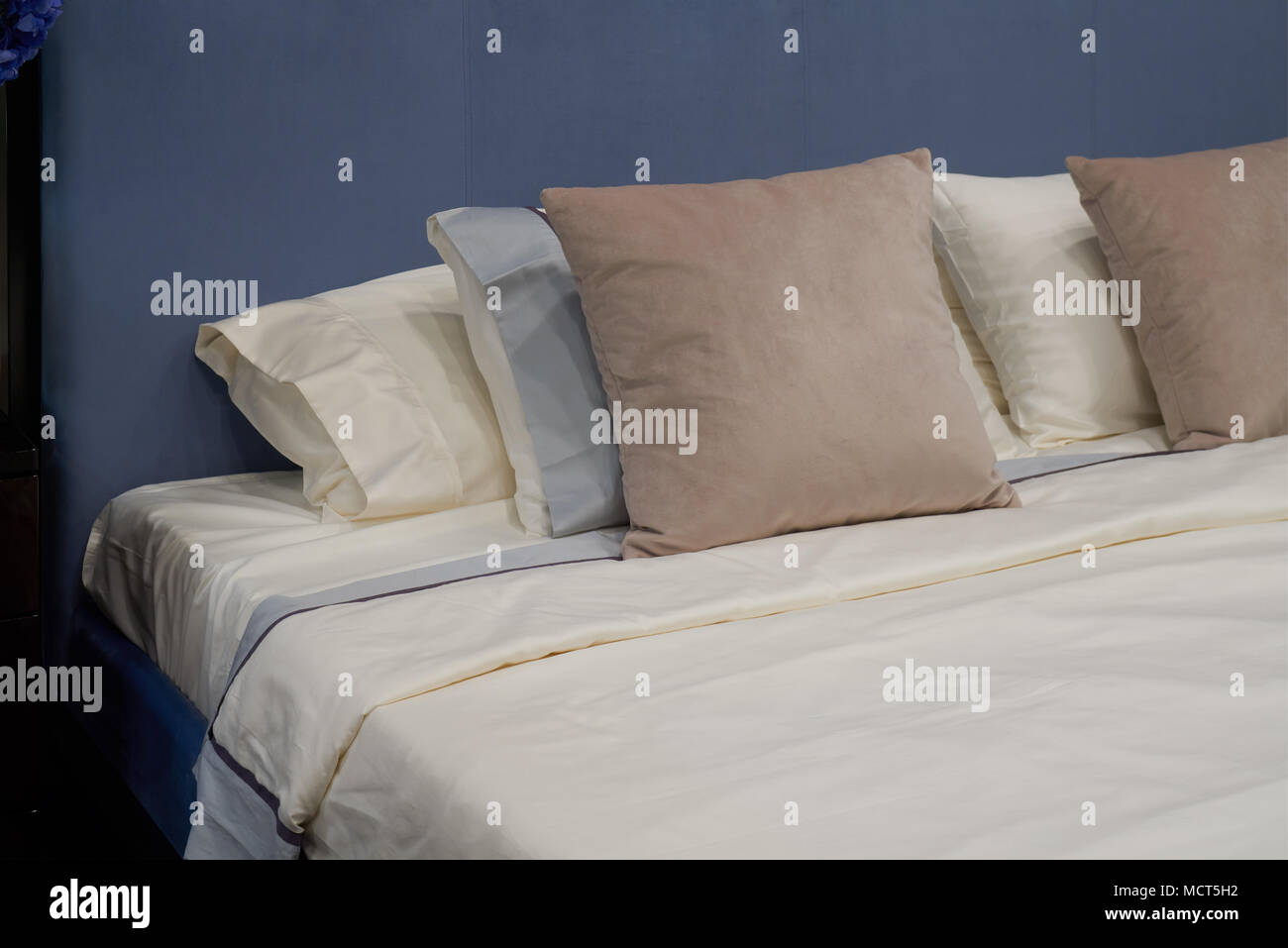 New comfortable double bed with beige pillows Stock Photo