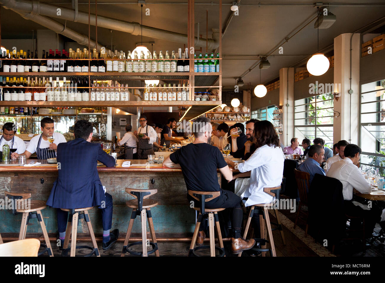 Patrons sitting at the bar area of Lardo. Lardo, Mexico City Stock
