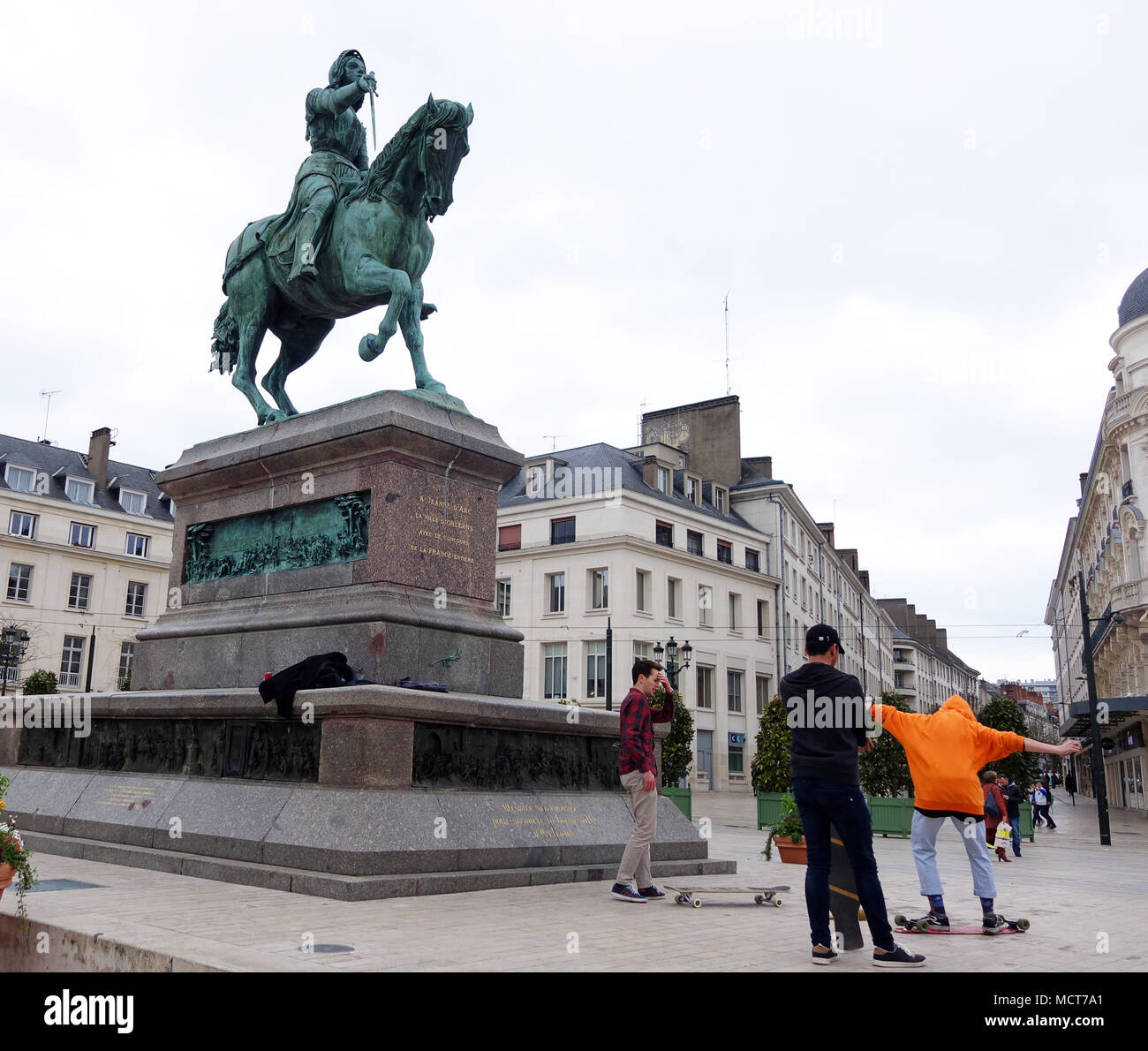 Joan of Arc statue and boys skate boarding on Orleans city Centre, France Stock Photo