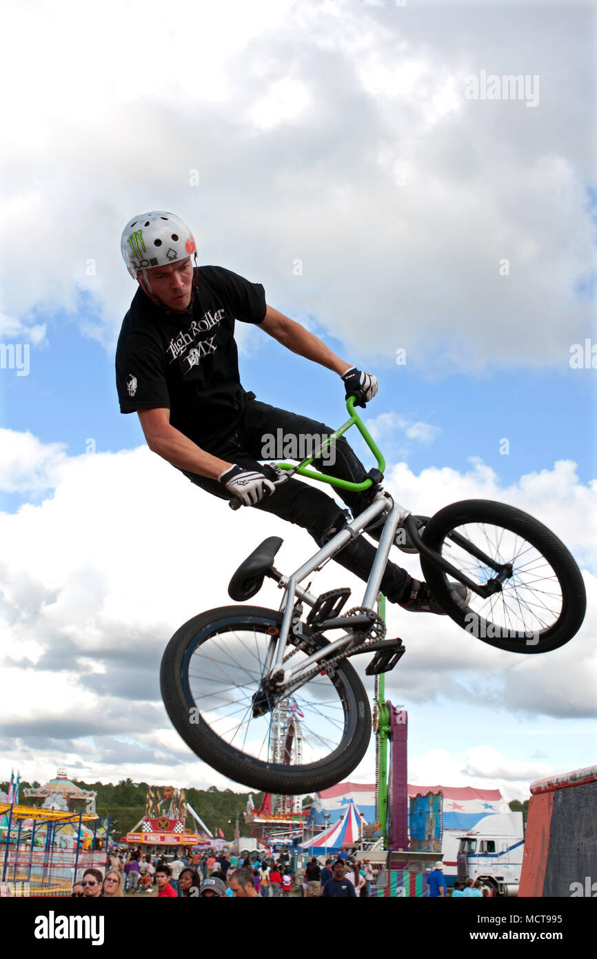 A young man with the High Roller BMX club spins his bike while performing a  BMX stunt at the Georgia State Fair on September 27, 2014 in Hampton, GA  Stock Photo - Alamy