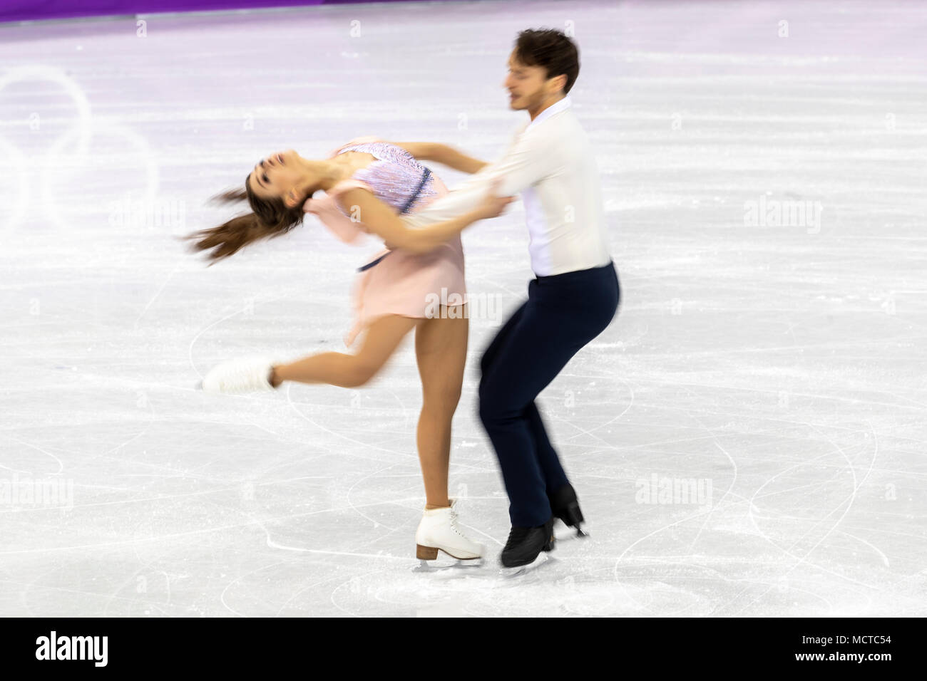 Motion blur action of Kavita Lorenz/Joti Polizoakis (GER) in the Figure Skating - Ice Dance Free at the Olympic Winter Games PyeongChang 2018 Stock Photo