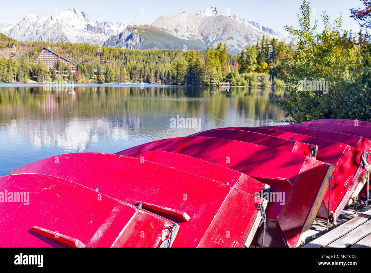 Red flipped over recreational boats on Strbske Lake shore in Slovakia. It is a favorite ski, tourist, and health resort in the High Tatras. Stock Photo