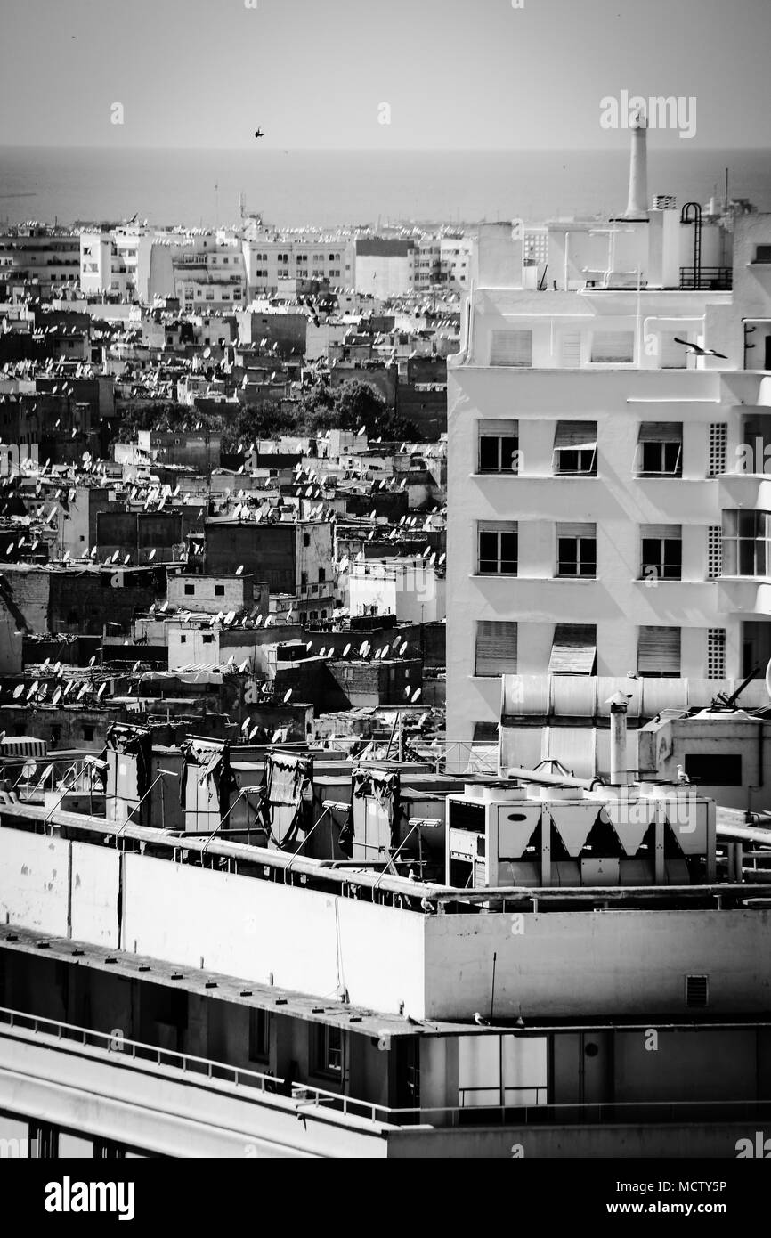 Old fashioned black and white picture of satellite dishes on a roof of a tall building in Casablanca, Morocco Stock Photo