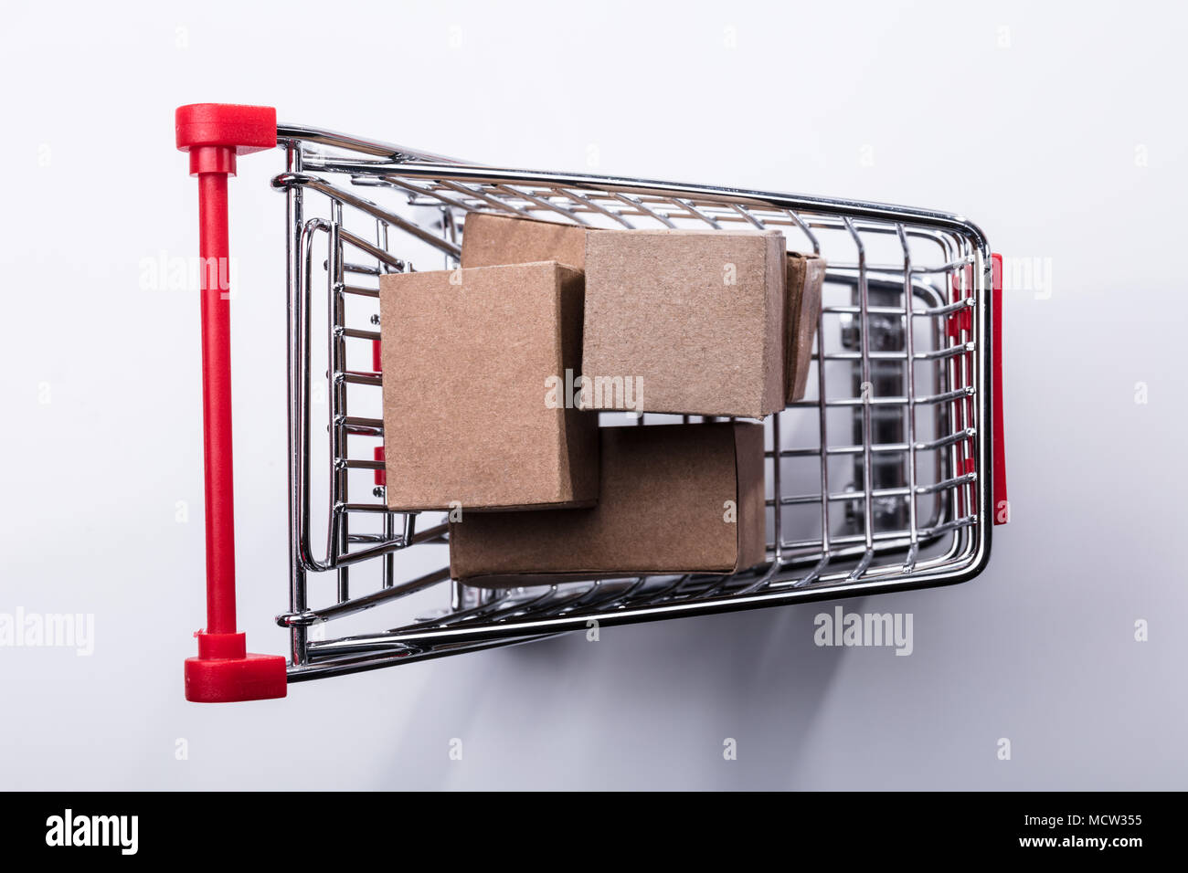 Close-up Of Shopping Cart With Cardboard Boxes Isolated On White ...
