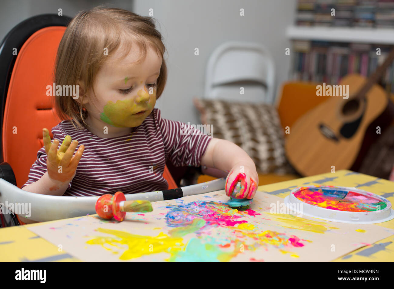Toddler painting at home Stock Photo