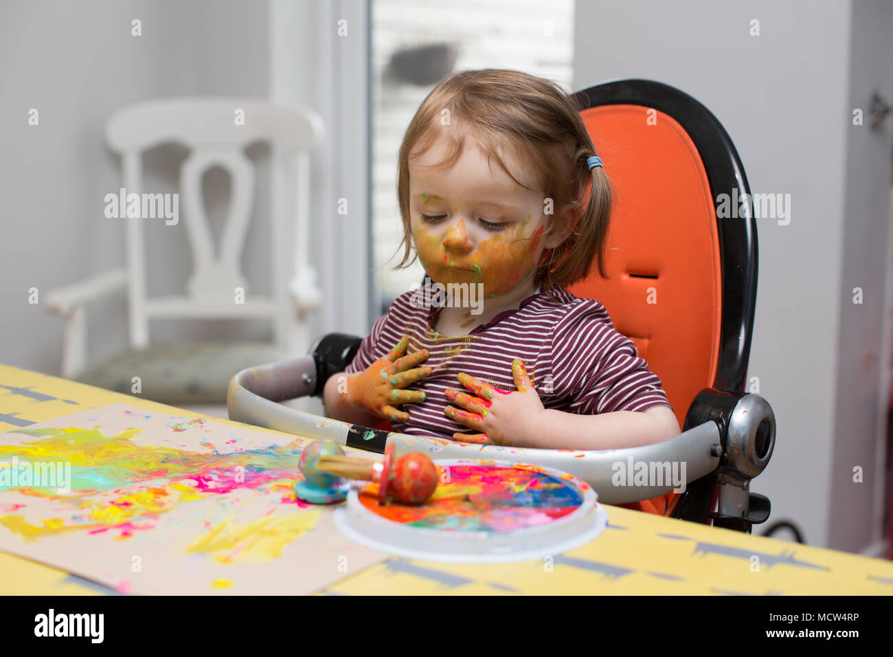 Toddler painting at home Stock Photo
