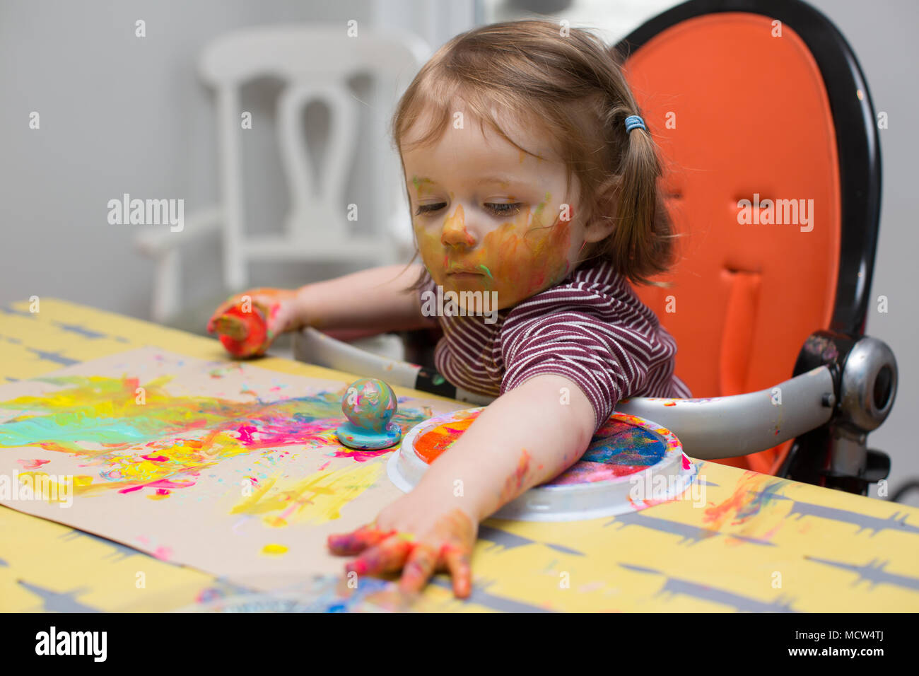 Toddler painting at home Stock Photo