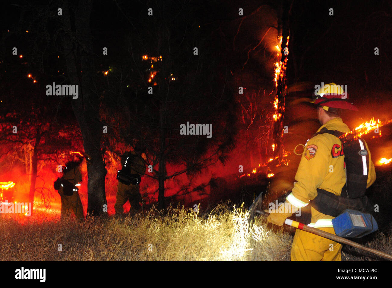 A firefighter evaluates his next strategic move during one of the numerous Lake County fires. Stock Photo