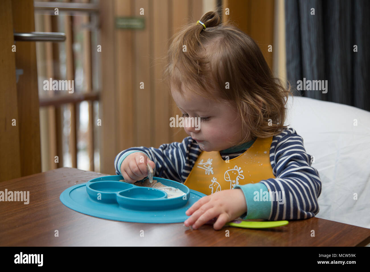 Toddler eating breakfast Stock Photo