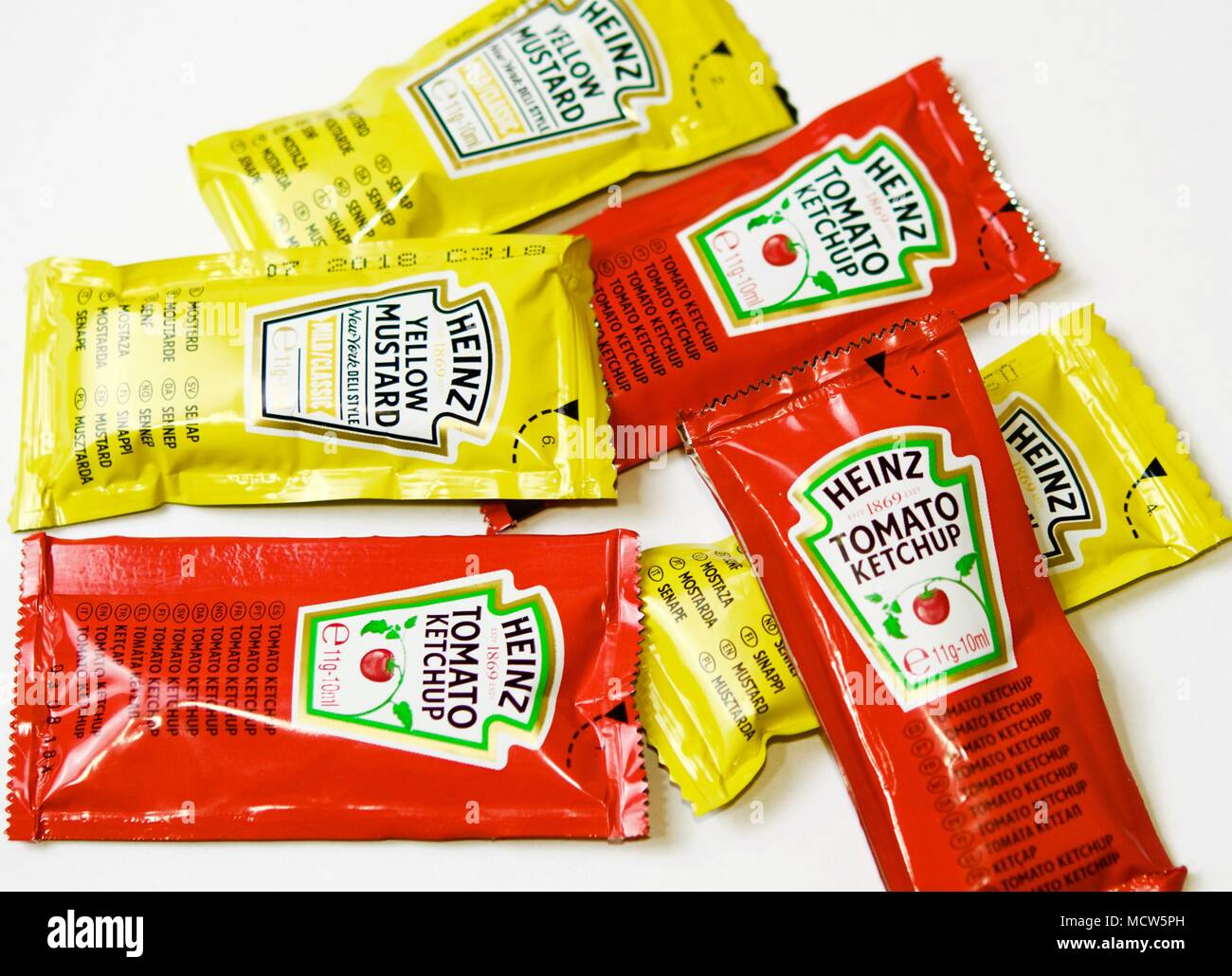 Ketchup and mustard from Heinz brand in sachets Stock Photo