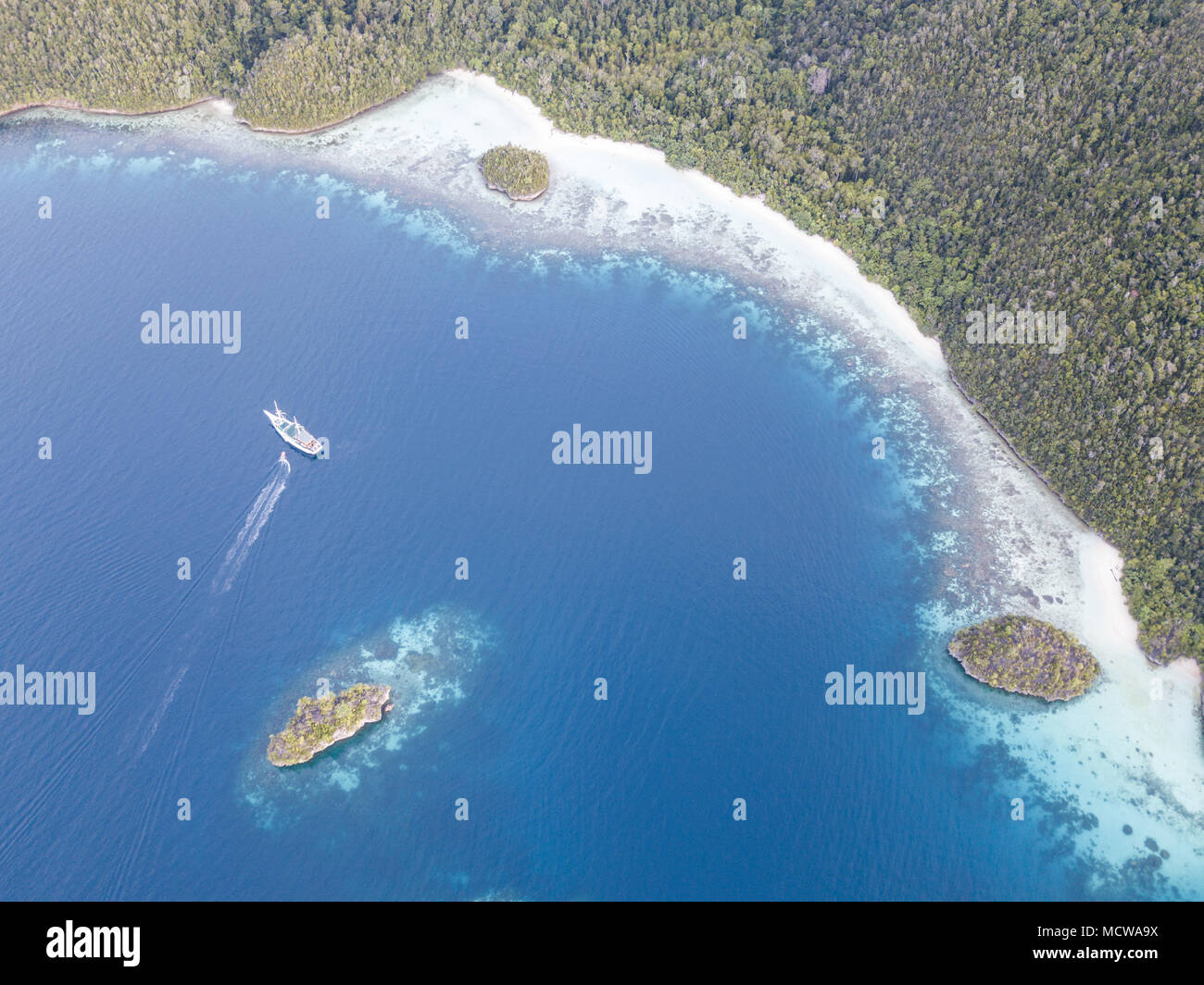 Beautiful limestone islands are fringed by coral reefs in Wayag, Raja