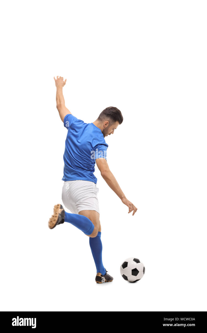 Full length rear view shot of a soccer player kicking a football isolated on white background Stock Photo