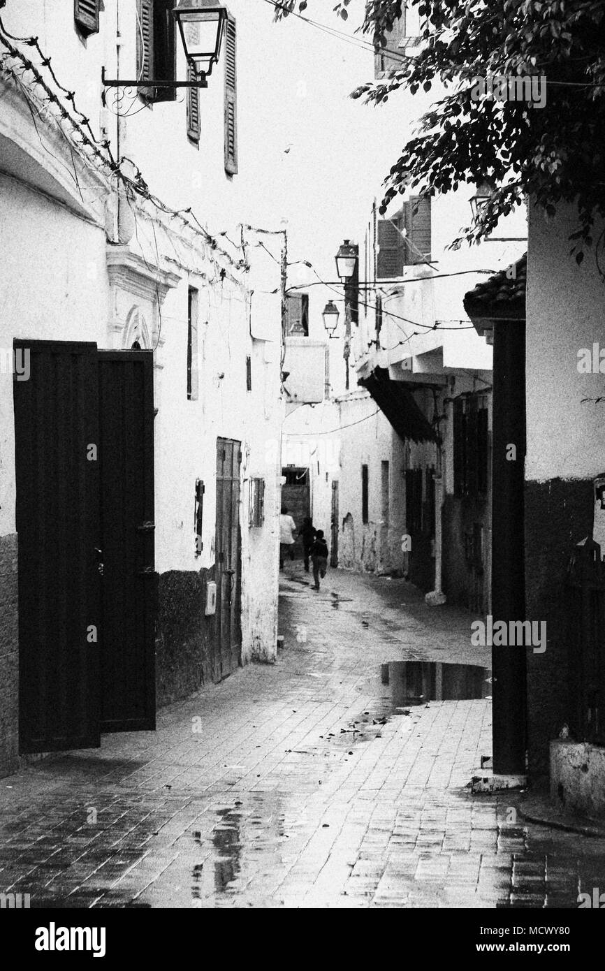 Old fashioned black and white picture of kids running through a narrow alley near the old souk in Casablanca, Morocco Stock Photo