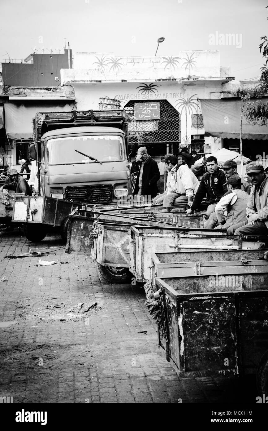 Picture of Arabian men waiting to transport bought goods with hand carts from the old souk in Casablanca, Morocco, to the facilites of the buyers Stock Photo