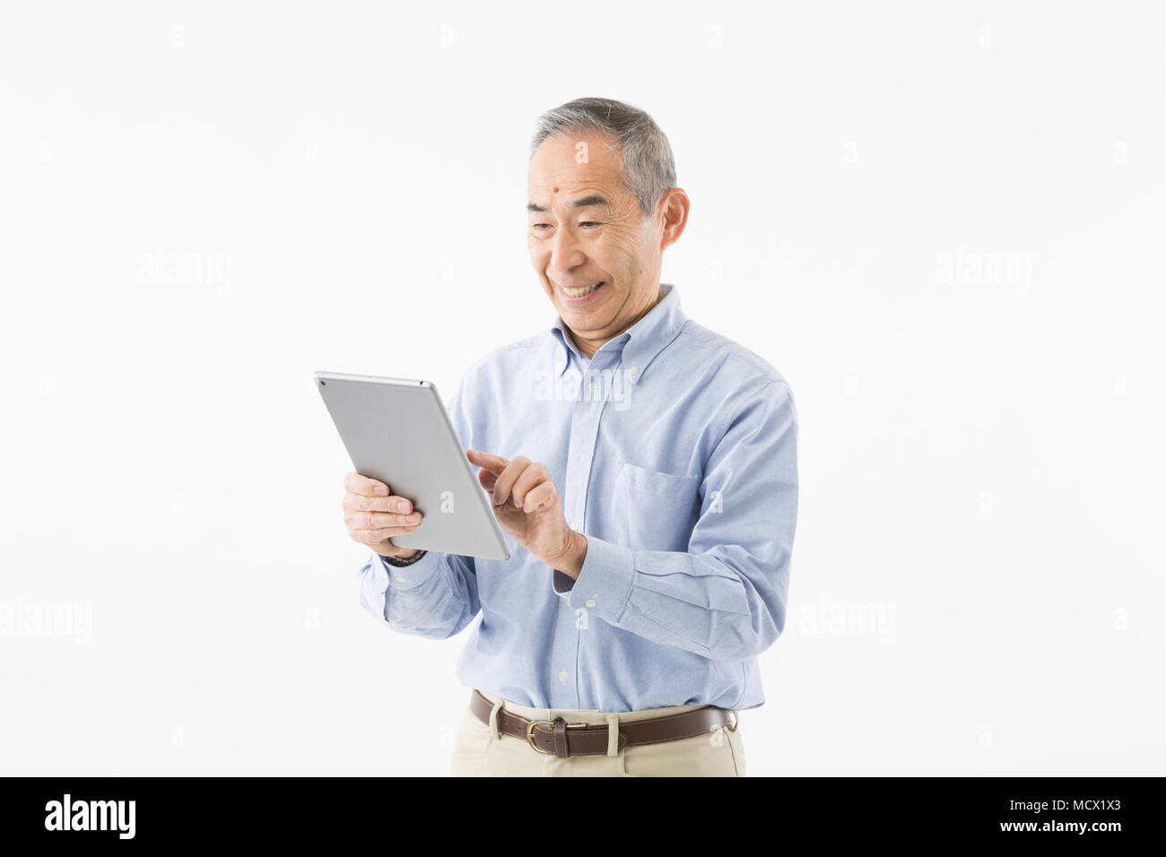 Senior man using tablet Stock Photo