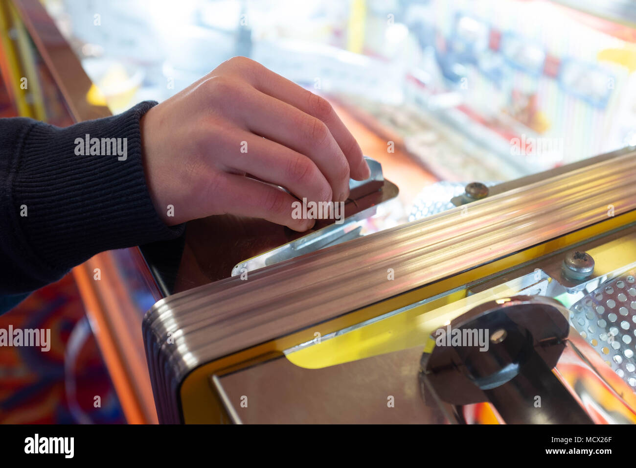 Playing slot machines at the amusement arcades in Skegness, UK Stock Photo