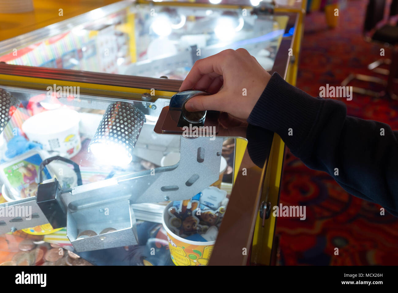 Playing slot machines at the amusement arcades in Skegness, UK Stock Photo