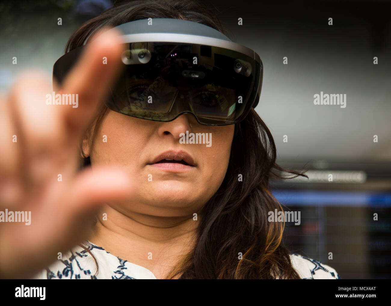 180302-N-PN275-1057 SAN DIEGO (March 02, 2018) Hiral Beg, a registered nurse in Naval Medical Center San Diego Tele-Critical Care Unit, demonstrates how to use the Microsoft Hololens a wearable augmented reality device. The Hololens is shares information between on site personnel and remote physicians, allowing for the physicians the make audio and visual guidance. (U.S. Navy Photo by Mass Communication Specialist 2nd Class Zach Kreitzer/Released) Stock Photo