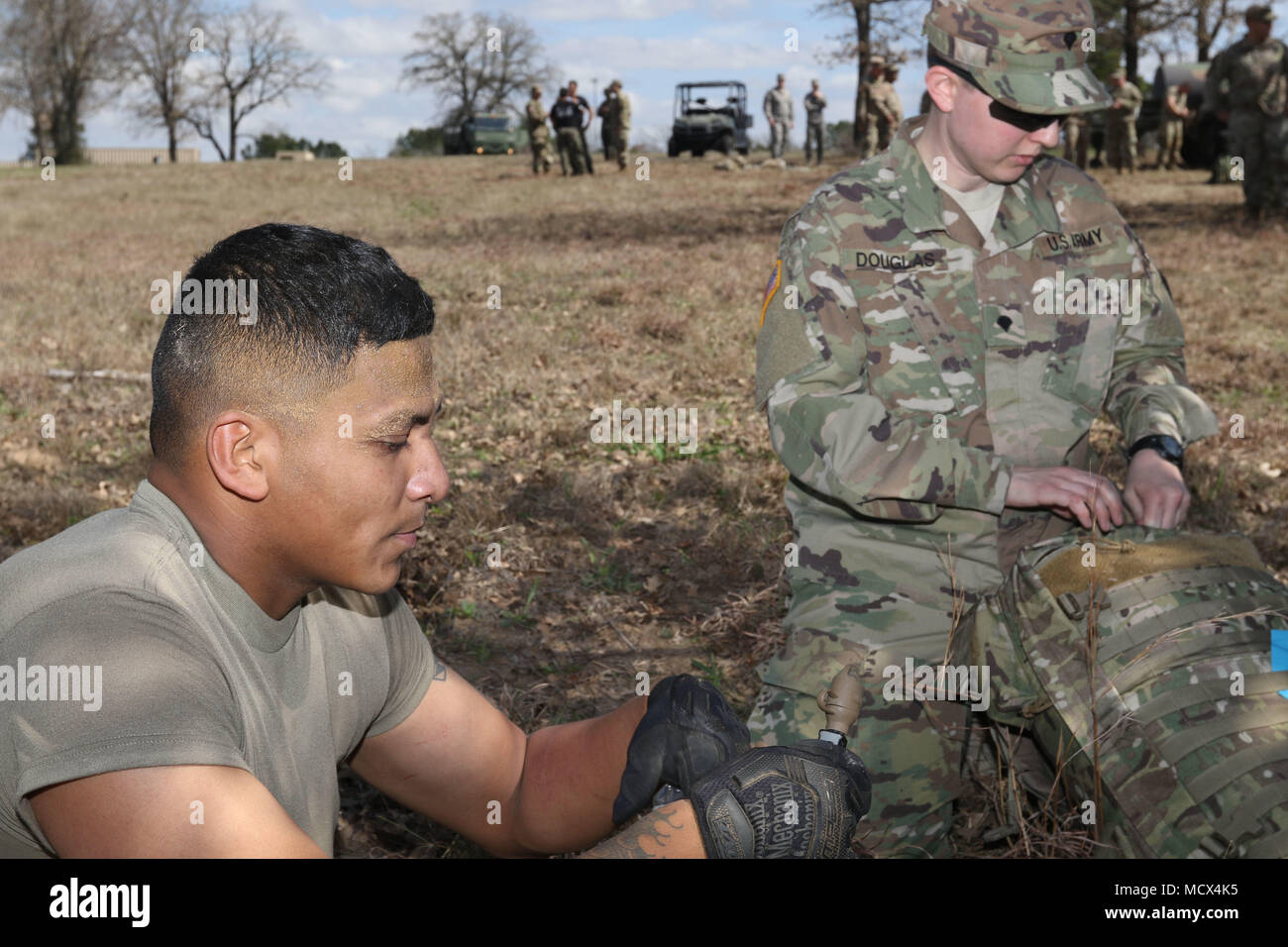 Texas Army National Guard Sgt. Ignacio Salas, 1st Battalion, 133rd Field  Artillery Regiment out of Houston, Texas, is evaluated by a medic following  completion of the Combat Obstacle Course event, March 1,