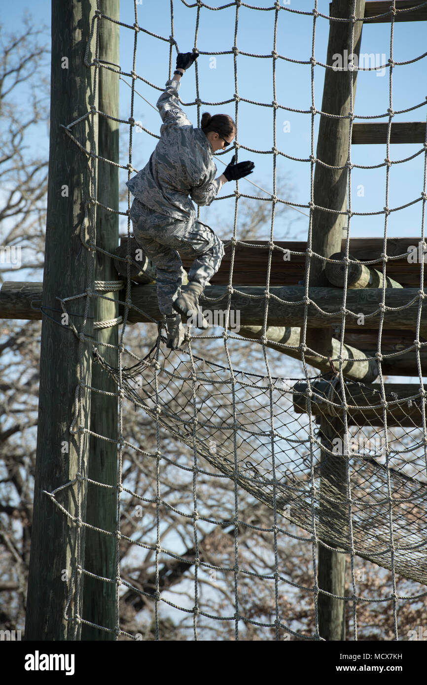 Tech. Sgt. Jennifer Brown, 273rd Cyber Operations Squadron education and  training specialist, Texas Air National Guard, climbs down some ropes  during an obstacle course at the 2018 Best Warrior Competition March 1,