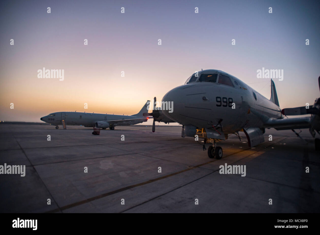 180301-N-CL765-003  U.S. 5TH FLEET AREA OF OPERATIONS (March 1, 2018) A P-3 Orion, left, assigned to Patrol Squadron (VP) 40, sits on the flight line adjacent to a P-8A Poseidon from the 'Mad Foxes' of Patrol Squadron (VP) 5. VP-5 is supporting missions in U.S. 5th Fleet to demonstrate cross-combatant command interoperability, deter potential adversaries and to provide large-scale intelligence, surveillance and reconnaissance collection. (U.S. Navy photo by Mass Communication Specialist 2nd Class Jakoeb Vandahlen/Released) Stock Photo