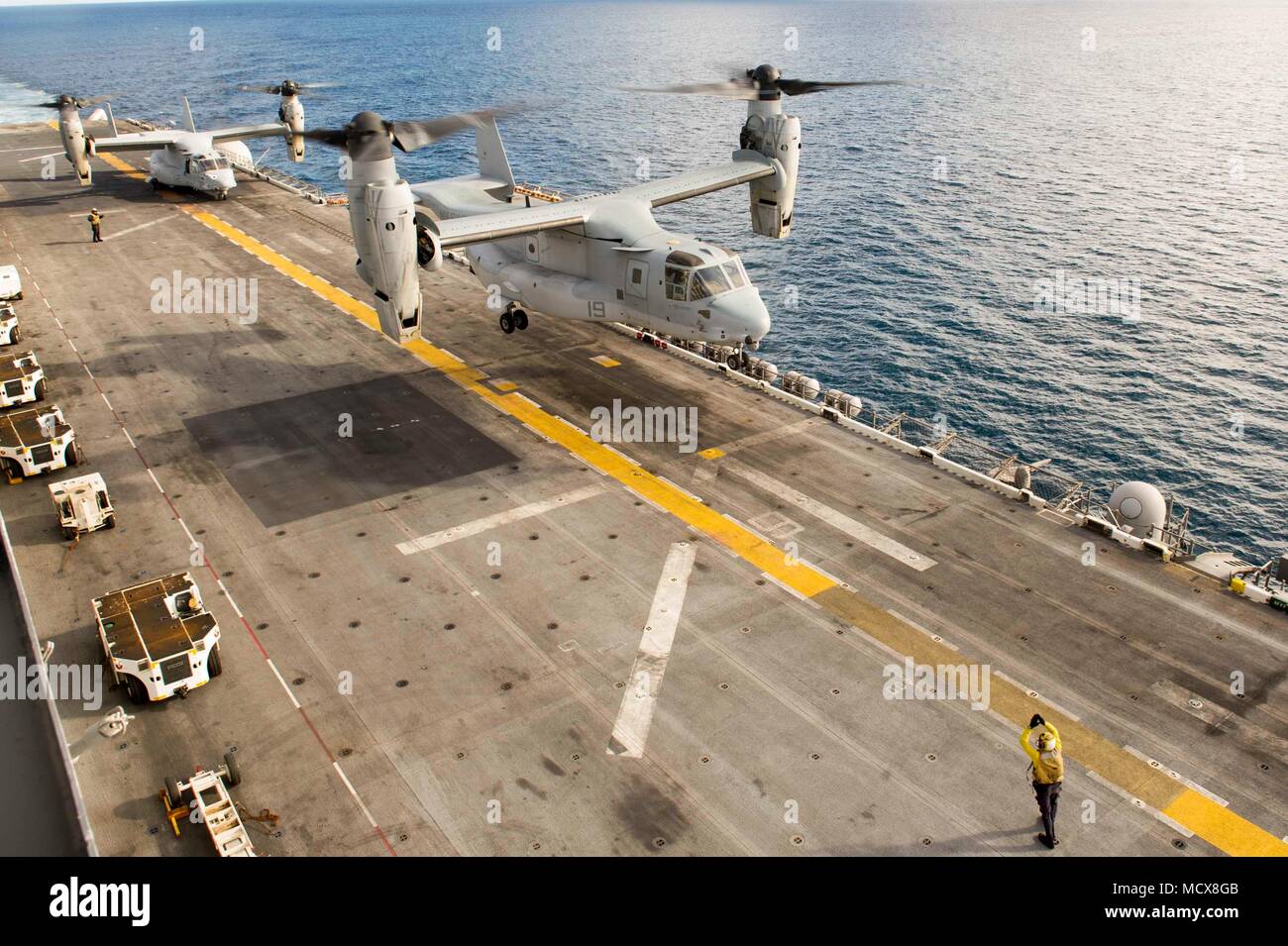 180302-N-ZS023-024 PACIFIC OCEAN (March 2, 2018) An MV-22B Osprey assigned to Marine Medium Tiltrotor Squadron (VMM) 161 aboard the amphibious assault ship USS America (LHA 6) lifts off from the flight deck. America is underway off the coast of southern California preparing for an ammunitions offload prior to entering a routine maintenance availability period. (U.S. Navy photo by Mass Communication Specialist 3rd Class Vance Hand/Released) Stock Photo