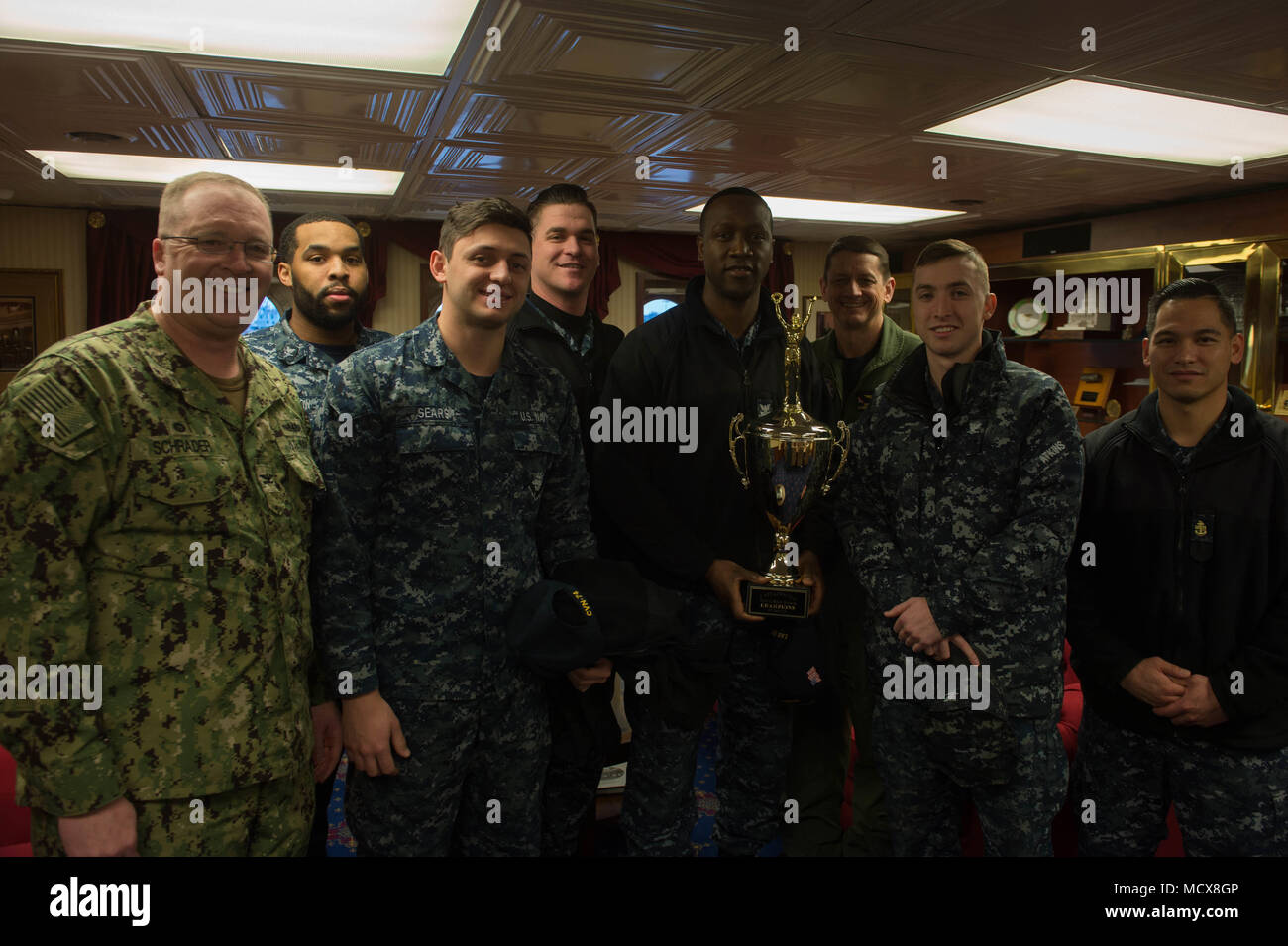 180302-N-QE928-012 BREMERTON, Wash. (March 2, 2018) John C. Stennis (CVN 74) Sailors, participants in Naval Base Kitsap Captain’s Cup events, pose for a photo with Capt. Greg Huffman, commanding officer of John C. Stennis, and Capt. Edward Alan Schrader, commanding officer of Naval Base Kitsap, aboard the ship. The Captain’s Cup is an element of the Navy’s intramural sports program and is presented to the team with the most points at the end of the calendar year.  John C. Stennis is in port conducting training as it continues preparing for its next scheduled deployment. (U.S. Navy photo by Mas Stock Photo