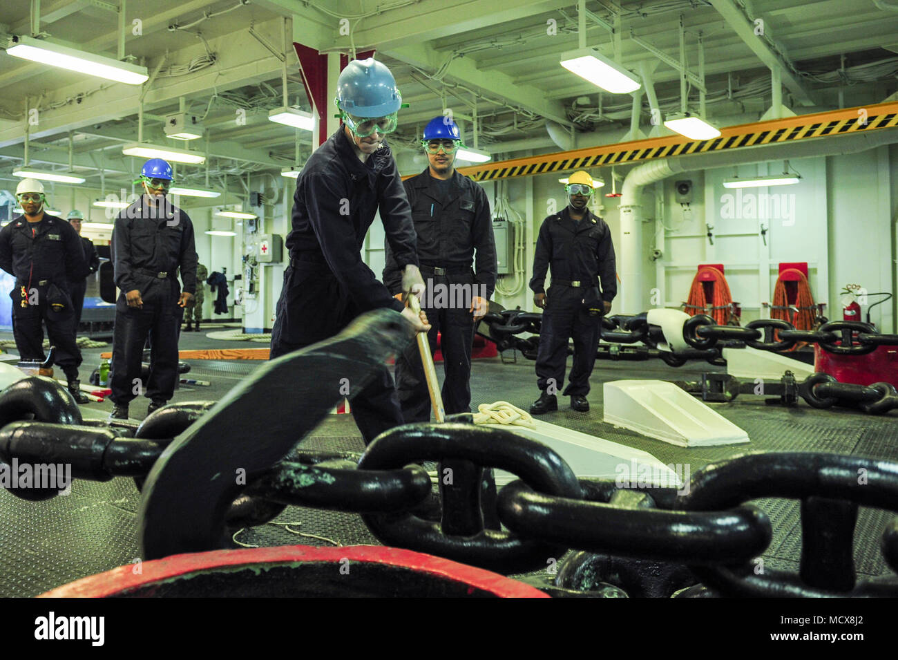 180302-N-ZS023-014 NAVAL BASE SAN DIEGO (March 2, 2018) Boatswain’s Mate 3rd Class Bradley Richardson, a native of Livingston, Texas, assigned to the amphibious assault ship USS America (LHA 6), disconnects a pelican hook in the forecastle as the ship departs Naval Base San Diego. America is getting underway off the coast of southern California preparing for an ammunitions offload prior to entering a routine maintenance availability period. (U.S. Navy photo by Mass Communication Specialist 3rd Class Vance Hand/Released) Stock Photo