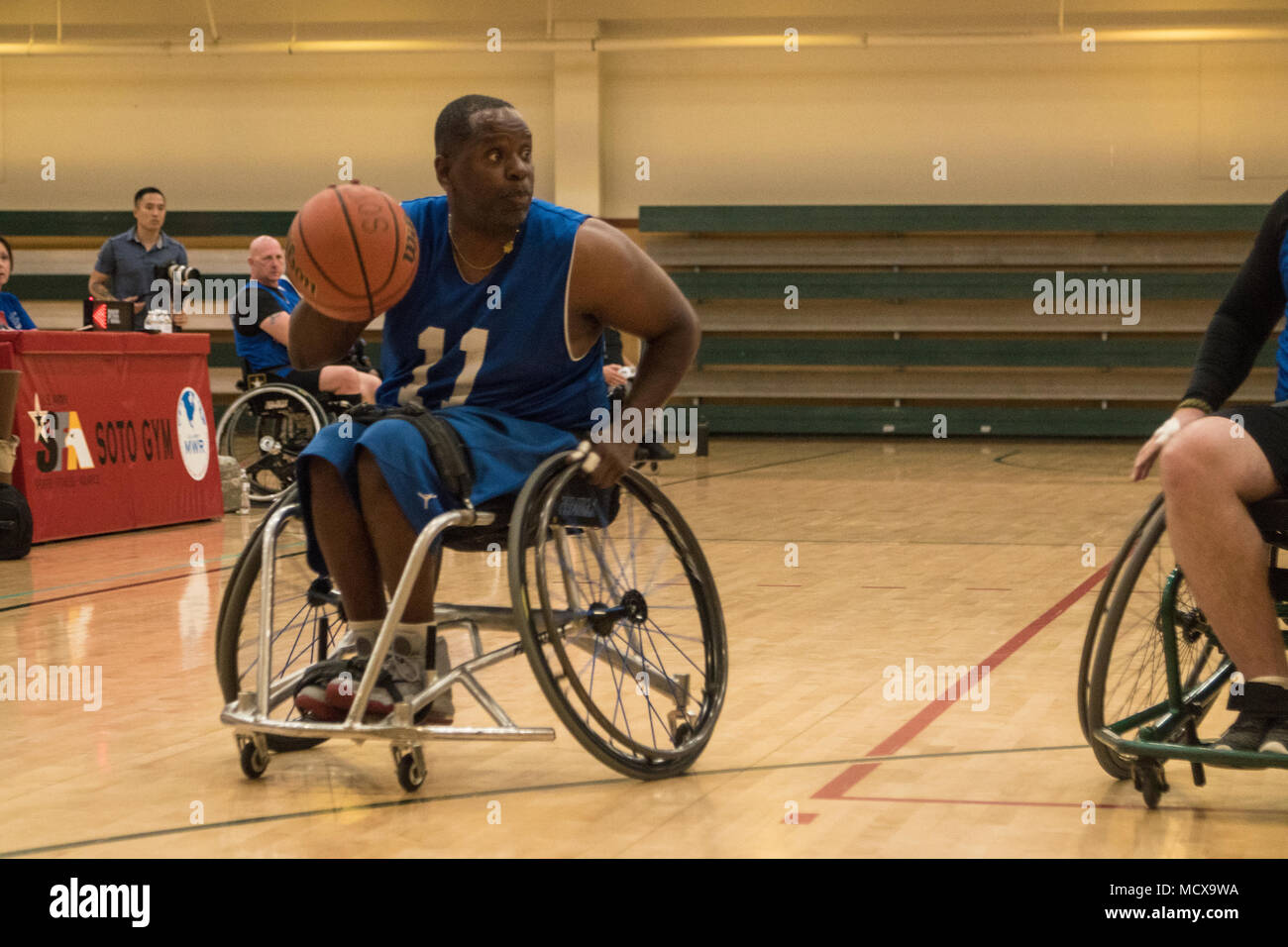 Retired U.S. Army Sgt 1st Class Carl Morgan, formerly assigned to the Warrior Transition Battalion, Fort Gillem looks for a teammate to pass the ball to during a game of Wheelchair Basketball at Fort Bliss, Texas, March 4, 2018. 74 wounded, ill or injured active duty Soldiers and veterans participate in a series of events that are held at Fort Bliss, Texas, Feb. 27 through March 9, 2018 as the Deputy Chief of Staff, Warrior Care and Transition host the 2018 Army Trials. (U.S. Army photo by Sgt. Brooks Schnetzler) Stock Photo