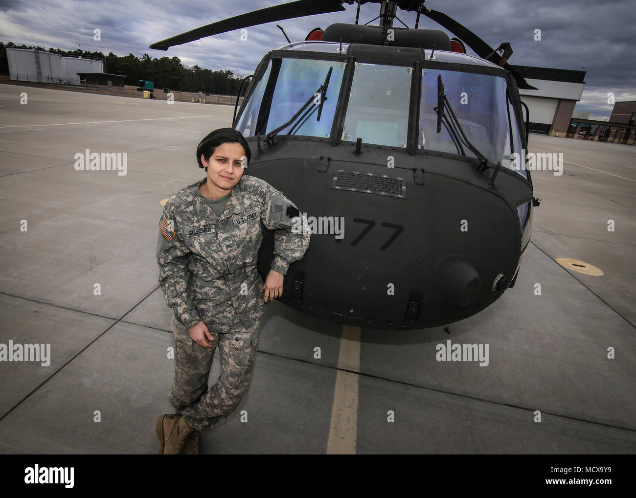 U.S. Army National Guard Cpl. Melinda Gulsever stands for a portrait with a UH-60L Black Hawk helicopter at the New Jersey National Guard's Army Aviation Support Facility, Joint Base McGuire-Dix-Lakehurst, N.J., March 5, 2018. Gulsever is an egine mechanic, and is also the head brewer for Backwards Flag Brewing Co. (U.S. Air National Guard photo by Master Sgt. Matt Hecht) Stock Photo